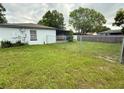 Fenced backyard featuring a chain-link fence and covered porch at 337 Live Oak Blvd, Sanford, FL 32773