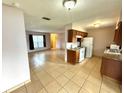 Open-concept kitchen and living area with tile floors and white appliances at 337 Live Oak Blvd, Sanford, FL 32773