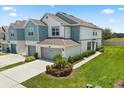 Stylish townhome featuring an attached two-car garage, a manicured lawn, and lush landscaping at 3600 Plainview Dr, Orlando, FL 32824