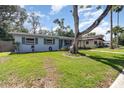 Single-story home with a well-maintained lawn and mature tree in a residential neighborhood at 436 Azores Ave, Orlando, FL 32811