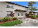 Inviting townhome showcasing mature trees, tidy landscaping, and an attractive covered entry at 5126 Saint Charles Ln # 43, Orlando, FL 32822