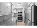 Well-lit kitchen featuring stainless steel appliances, granite counters, and sleek backsplash at 5126 Saint Charles Ln # 43, Orlando, FL 32822