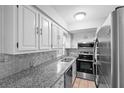 Bright kitchen with stainless steel appliances, neutral countertops, and ample cabinet space at 5126 Saint Charles Ln # 43, Orlando, FL 32822