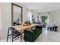 Bright dining area featuring a modern table set, decor, and an open layout leading to the living room at 6006 Galloping Dr, Apopka, FL 32712