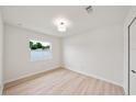 Bright bedroom features wood floors, a large window, and neutral walls, ready for personal touches at 772 Whippoorwill Dr, Orlando, FL 32825