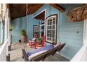 Inviting front porch featuring a swing, rocking chairs, and wood ceiling at 8718 Fort Shea Ave, Orlando, FL 32822