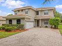 Charming two-story home with a well-manicured lawn and a paved driveway at 9034 Paolos Place Paolos Place, Kissimmee, FL 34747