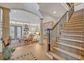 Open-concept living room featuring tile floors, a staircase with iron railing, and views to the backyard at 922 N Pennsylvania Ave, Winter Park, FL 32789
