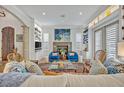 Bright and airy living room featuring custom built-ins, fireplace and comfortable seating at 922 N Pennsylvania Ave, Winter Park, FL 32789