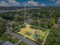 Aerial view of land lot surrounded by lush greenery in a suburban neighborhood at 9329 7Th Ave, Orlando, FL 32824