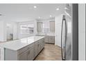 Kitchen featuring stainless steel refrigerator, kitchen island, with ample counter space at 9941 Introduction Way, Orlando, FL 32832