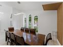 Spacious dining room with a long table, seating for eight, and natural light at 10001 Newington Dr, Orlando, FL 32836