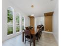 Bright dining room with large windows and modern light fixture at 10001 Newington Dr, Orlando, FL 32836