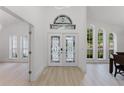 Bright foyer with decorative glass double doors and windows at 10001 Newington Dr, Orlando, FL 32836
