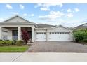 Beautiful single-story home with a three-car garage, brick-paved driveway, and a nicely landscaped front yard at 1091 Wood Dale Cir, Oviedo, FL 32765