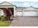 Charming home exterior featuring a two-car garage and meticulously manicured landscaping at 1091 Wood Dale Cir, Oviedo, FL 32765