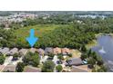This aerial view showcases the property's location near a serene lake and verdant green spaces at 11236 Rouse Run Cir, Orlando, FL 32817