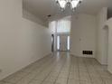 Bright living room with ceramic tile floors and lots of natural light shining through the front door at 11236 Rouse Run Cir, Orlando, FL 32817