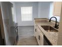 The kitchen features sleek stainless steel appliances and granite countertops at 11588 Westwood Blvd # 1523, Orlando, FL 32821