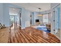 Bright, open living space with wood floors, stylish lighting and decor, and easy access to the kitchen at 11616 Thacker Dr, Clermont, FL 34711