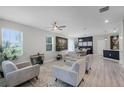 Bright living room with modern furnishings, sleek ceiling fan, and lots of natural light at 1391 Shinnecock Hills Dr, Davenport, FL 33896