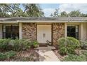Close-up of a classic brick facade and bright double doors at 1425 Mt Laurel Dr, Winter Springs, FL 32708