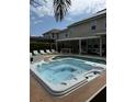 Backyard with an in-ground hot tub, with an outdoor kitchen and plenty of patio furniture for relaxation at 14744 Spotted Sandpiper Blvd, Winter Garden, FL 34787