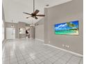 Open-concept living room featuring vaulted ceilings and neutral tiling at 1706 Terra Cota Ct, Orlando, FL 32825