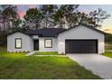 Charming single-story home featuring a well-manicured lawn and a two-car garage at 17465 Sw 41St Cir, Ocala, FL 34473