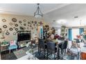 Spacious living area with dining table and chairs, perfect for entertaining guests at 1907 Myakka Ct, Poinciana, FL 34759