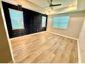 Spacious bedroom features modern lighting, a textured accent wall, and hardwood flooring at 2035 White Feather Loop, Oakland, FL 34787