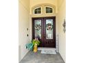 Elegant double front doors adorned with wreaths, enhancing curb appeal and offering a warm welcome to guests at 2051 Sandy Garden Ln, Winter Garden, FL 34787