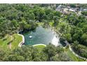 Stunning aerial view of a natural pond surrounded by lush greenery in a serene community at 211 Crown Oaks Way # 205, Longwood, FL 32779