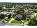 Gorgeous aerial view of home on a cul-de-sac with backyard waterfront access to a lake in a lush green community at 213 N Monterey Isle, Longwood, FL 32779