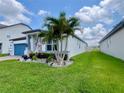 Well-manicured lawn and tropical landscaping accentuate the exterior of this charming single Gathering home at 2390 Standing Rock Cir, Oakland, FL 34787