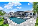 Inviting pool area with screened enclosure, outdoor dining, and lounging spaces for relaxation at 2390 Standing Rock Cir, Oakland, FL 34787