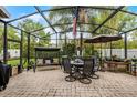 Relaxing screened-in patio with comfortable seating, perfect for outdoor dining at 2418 Ridgemooor Dr, Orlando, FL 32828