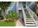 Close up exterior showcasing the staircase, siding, and landscaping at 2501 Grassy Point Dr # 107, Lake Mary, FL 32746