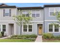 Charming townhouse with blue siding, tidy landscaping, and a welcoming yellow front door at 3028 Water Sprite St, Orlando, FL 32808
