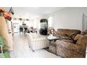 Spacious living room with tile floors and an open floor plan to the kitchen at 309 E 13Th St, Apopka, FL 32703
