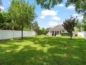 Large, fenced backyard with lush green lawn offers privacy and space for outdoor enjoyment at 3535 Lake Sarah Dr, Orlando, FL 32804