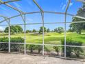 Relax on the screened patio and enjoy the serene views of the beautiful golf course at 36730 Oconee Ave, Eustis, FL 32736