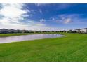 Large backyard overlooking serene lake, providing a peaceful and picturesque setting for outdoor activities at 3943 Crawley Down Loop, Sanford, FL 32773