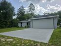 A view of the driveway leading to the two car garage in this well maintained single-story home at 4325 Sw 157Th Ter, Ocala, FL 34481