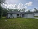 Charming single-story home with green grass, tasteful landscaping, and a paved driveway at 4325 Sw 157Th Ter, Ocala, FL 34481