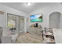 Bright dining area featuring wood-look floors, sliding doors to the outdoors, and stylish accents, ideal for casual dining at 4865 Gorham Ave, Orlando, FL 32817