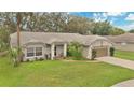 Charming single-story home with well-manicured lawn, mature trees, and welcoming front entrance, complete with a two-car garage at 4865 Gorham Ave, Orlando, FL 32817