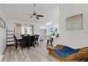 Bright living area with modern ceiling fan, dining table, wood-look floors, and sliding doors to the outdoors, perfect for entertaining at 4865 Gorham Ave, Orlando, FL 32817