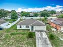 Scenic aerial view of a neighborhood, featuring a well-maintained home with a long driveway at 5125 Pine Needle Dr, Mascotte, FL 34753