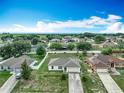 Wide aerial shot showcasing a well-planned community with tidy lawns and beautiful landscaping at 5125 Pine Needle Dr, Mascotte, FL 34753
